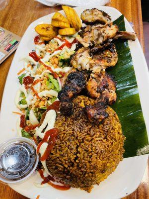 Jollof rice Combo -paired with Jerk Grilled Chicken, fried plantain, and Ghana salad.