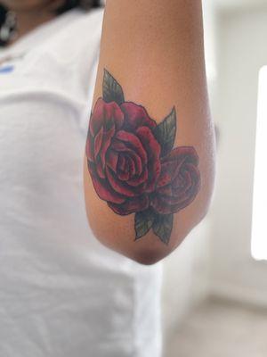 Traditional red roses (coverup) on elbow