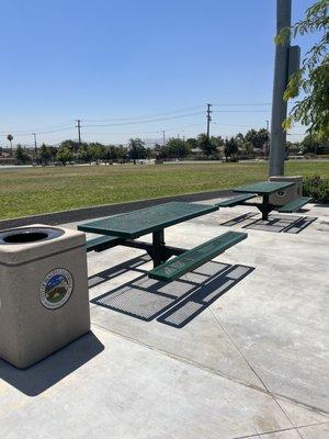 In shaded picnic tables