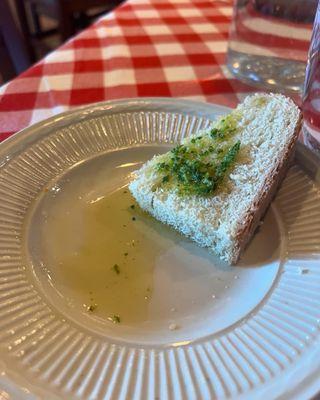 Fresh bread with olive oil and pesto, roasted peppers  on the side.