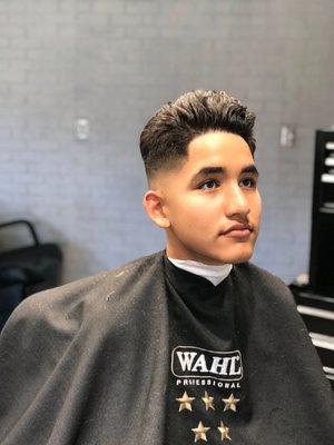 Skin fade with a twist on a pompadour