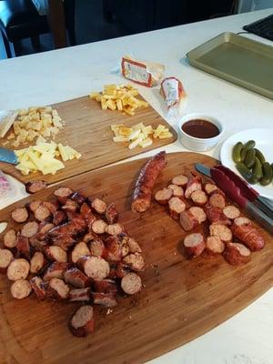 chicken-apple sausages, gator sausage. Crisped on the grill Memphis-style, w/ cheese, BBQ sauce and sweet gherkins