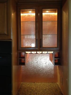 In This wine cabinet we installed low voltage Seagull linear lights and a puck light for the upper cabinet