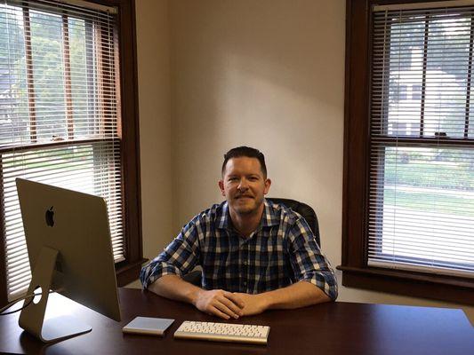 Dr. Parker at his desk.