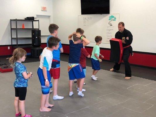 Kids Day Out - practicing kicks and punches.