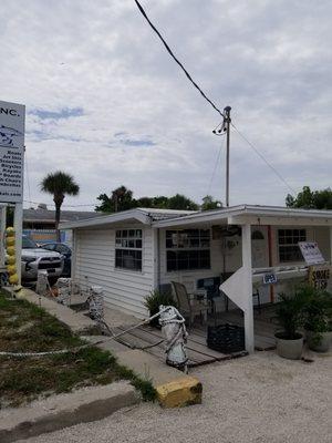 Go inside this little white building called Island Court Inc.to book a boat trip.