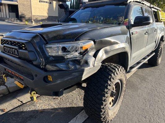 Damaged bumper, headlight, panel, trim, grill and hood.