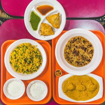 Clockwise from left, vegetable Biryani, Samosas, Aloo Paratha, Malai Kofta