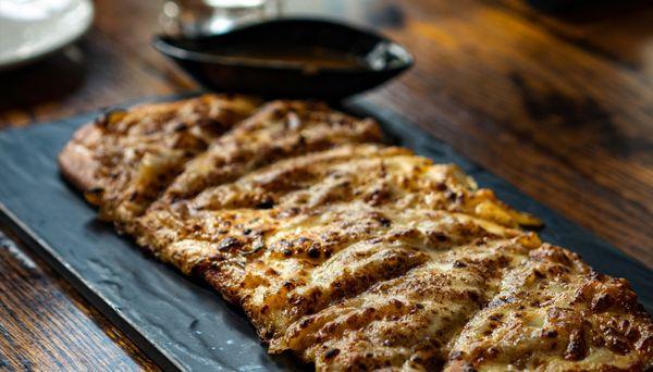 FRENCH ONION SOUP FLATBREAD Caramelized sweet onions, provolone cheese, Au Jus