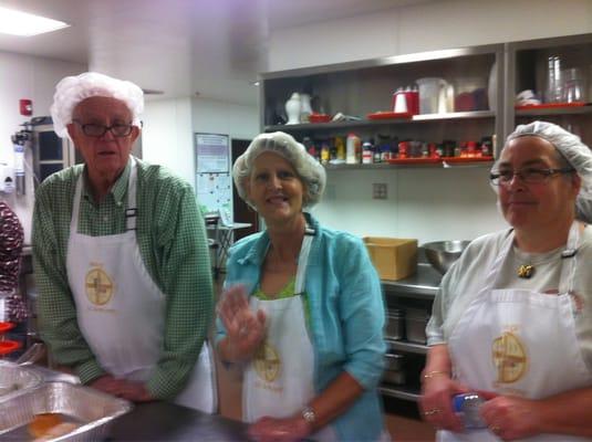 Members of St Anthony on the Desert serving a meal at EVMC.