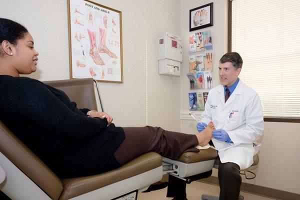 Dr. Alan Boehm examines a patient's foot at Raleigh Foot & Ankle Center.