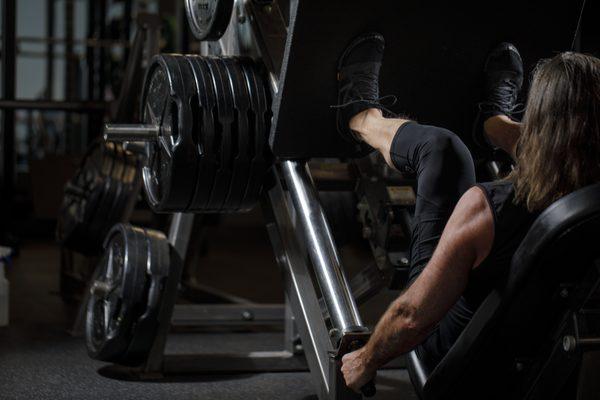 Weight room with multiple racks, new deadlift platform, new bumper plates, and more!