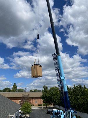 Flying AC unit to rooftop with a Crain