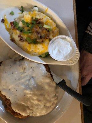 Chicken fried steak with loaded baked potato.