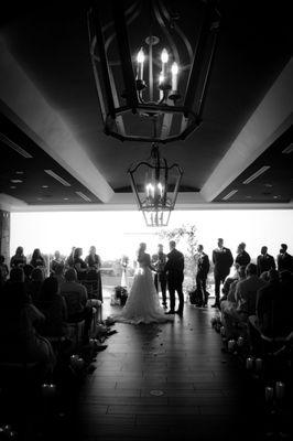 Indoor wedding venue aisle with the venue's gorgeous wood lights and a wide aisle