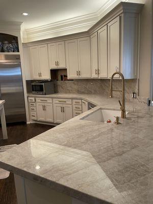 Full quartzite countertops for kitchen and backsplash.