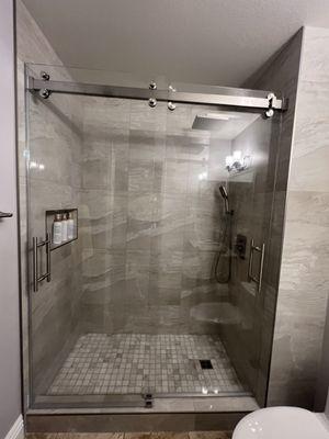 Custom dual sliding barn style shower doors. Local Glass company.