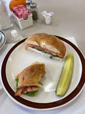 Lox and Bagel with cream cheese, lettuce, tomato, and capers.