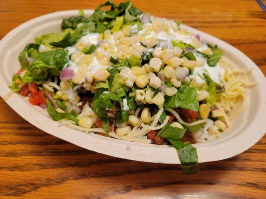 White rice, steak, fajita veggies, corn salsa, pico de gallo, cheese, sour cream, lettuce and guacamole.