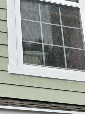 Paint on the house and the wood on the left is cracked or something it doesn't meet up and different types of wood or texture.