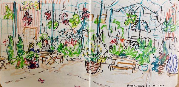 Sketch of women eating among plants at picnic tables inside a greenhouse