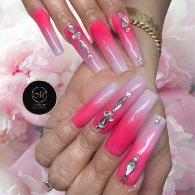 Acrylic nails in a tapered square shape, featuring a vibrant ombré of bright pink and silver rhinestones.