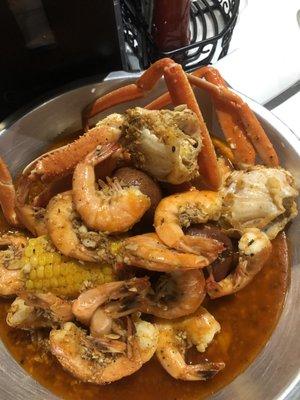 Shrimp, crab legs, corn, red potatoes in garlic- butter, Cajun sauce.