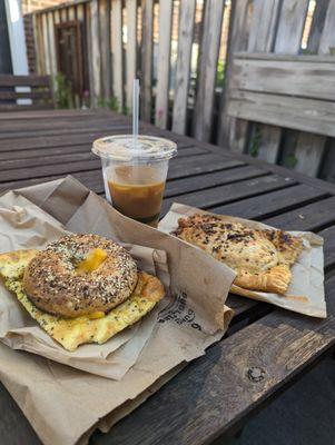 everything bagel with egg and cheese, iced coffee, pierogi hand pie