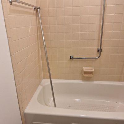 Bath after reno. Removed shower rod and replaced with "tension rod" after complaint to HUD of no rod in shower.