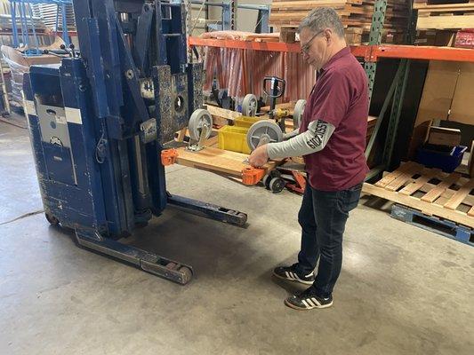 Greg putting together a wood platform truck for a customer.