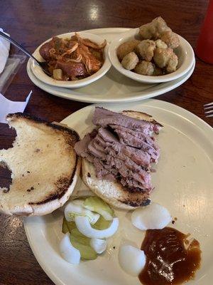 Sliced brisket sandwich, okra and jambalaya sides.