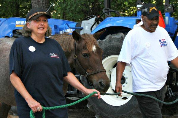 Clients of Alpha Omega Veterans Services leading horses at the Germantown Charity Horse Show with Southern Reins Center for Equine Therapy