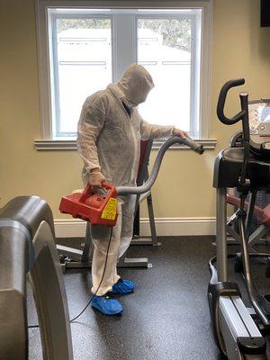 Wet fogging EPA listed disinfectant on some gym equipment at a local country club