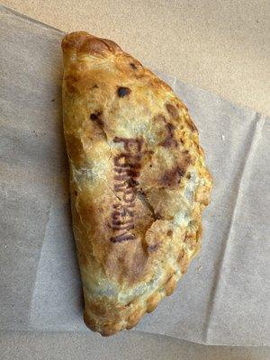 Freshly warmed pumpkin empanada