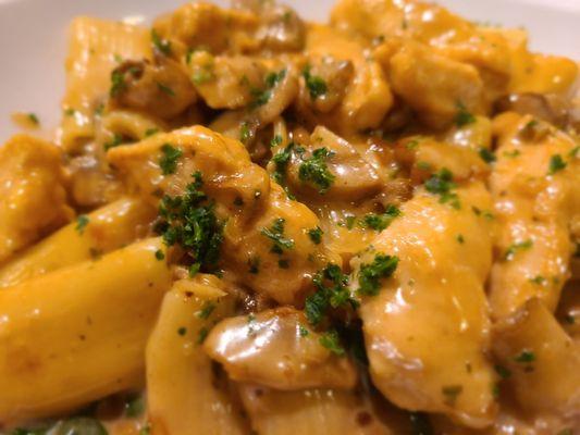 Creamy chicken marsala over sauce sopping rigatoni and spinach.