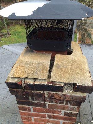 A severely cracked chimney crown and damaged mortar joints below.