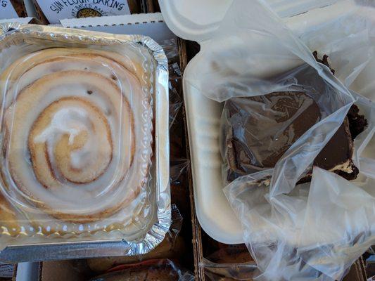 Sunflour baking cinnamon roll and peanut butter brownie on top of cookie sandwiches