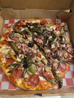 Meat Lover's pizza with two additional toppings, onions and green peppers