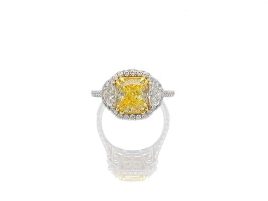 Cushion fancy yellow and half-moon white diamond ring.