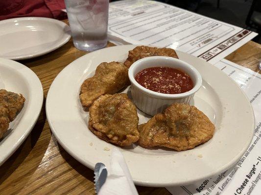 These ravioli are in what I can only describe as a "wonton-style" wrapper. The red sauce in that little jacuzzi is very tasty!