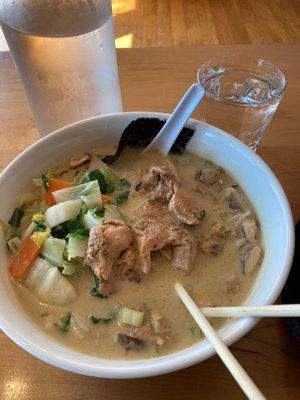 Spicy chicken, coconut curry soup with lemon grass, mushrooms and bamboo shoots with carrots.