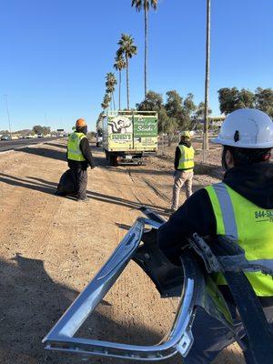 Crews loading trucks while working on roadways