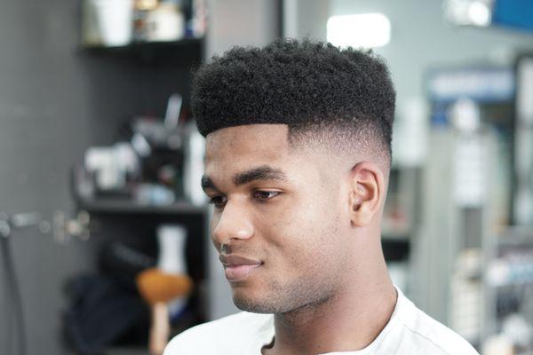 Check out this fade with a sponge curled top