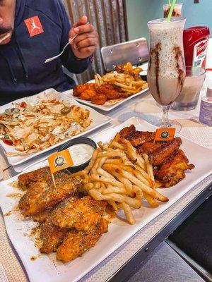 15 pc Lemon pepper wings and Honey garlic wings with fries. Appetizer was the Hawaiian bbq chicken nachos. Buschwacker drink.