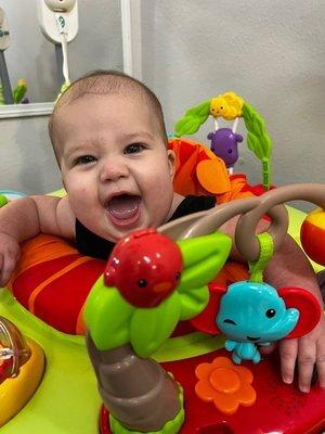 Picture from daycare sent to me of baby girl playing in bouncer !