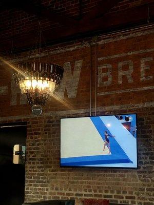 Beer bottle chandelier. Olympics on the tv.