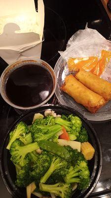 Steamed veggies, brown sauce on the side, beef spring rolls, white rice.