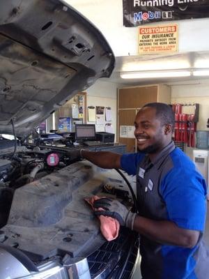 Store manager performs a oil change service.