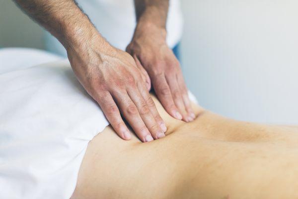 Therapeutic Massage in Laguna Niguel. Our client having a massage for lower back pain at the best massage therapy place in Laguna Niguel