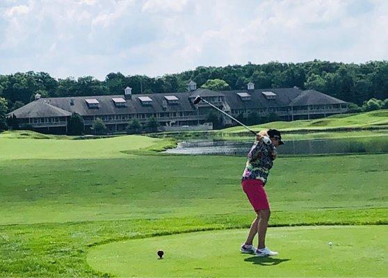 Teeing off on Hole # 18.  Huge Clubhouse and Banquet Center beyond.